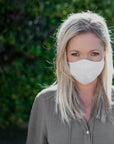 Woman Wearing a Kind Face Reusable Linen Face Mask in Natural Colour
