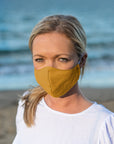 Woman Wearing a Kind Face Reusable Linen Face Mask in Golden Harvest Colour