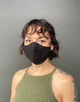 Woman Wearing a Kind Face Reusable Linen Face Mask in Black Colour