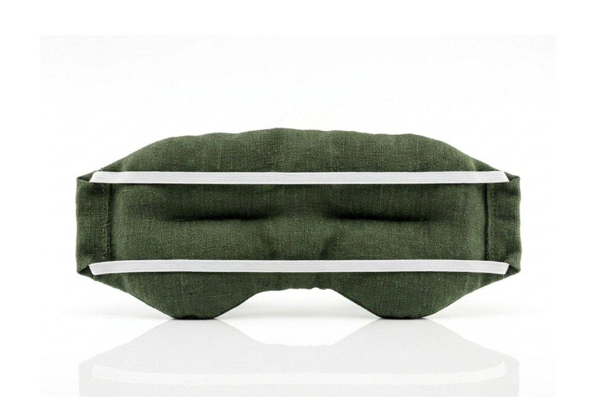 Back of Weighted Eye Mask in Moss Green linen and showing twin-strap organic cotton elastic displaying on a white background
